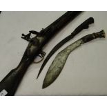 An Antique flintlock rifle and 2 Eastern knives.