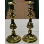 A pair of Victorian turned brass ejector candlesticks.