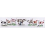 A group of seven 19th century Staffordshire pottery cow creamers