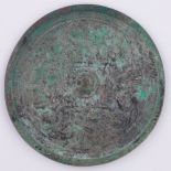 A Chinese circular bronze mirror, Eastern Han dynasty Ad 25 - 220, decorated in high relief with the