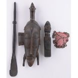 A group of 4 African carvings, comprising Senufo mask, a Congo fetish figure, a beaded pubic cover &