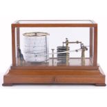 An early 20th century walnut cased barograph, in glazed panelled case with single drawer below,