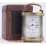 A French oval brass cased carriage clock, enamel dial, retailer Waring & Gillow, London, height