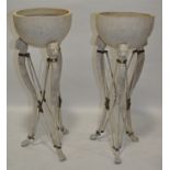 A pair of composition classical design torchere bowls on painted metal stands, height 3'10".