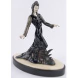 A modern painted metal and porcelain Art Deco style figure of a lady, on 2-colour marble plinth,