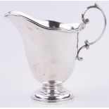 A large size silver cream jug, makers marks F & P, London 1923, 6.1oz, height to spout 12cm.