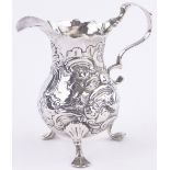 A George II silver cream jug, chased and embossed birds and flowers, indistinct makers marks,