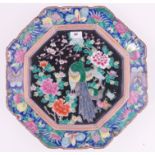 A large Chinese porcelain charger, painted peacock and blossom tree designs, width 43cm.