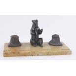 An Art Deco marble and bronze patinated spelter desk stand, surmounted by a bear, length 34cm.