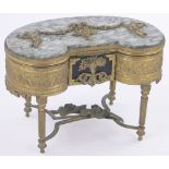 An ornate French gilt metal jewel box in the form of a kidney shaped dressing table,