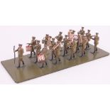 A die-cast military marching band, mounted on display board, length 25cm.
