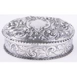 A Victorian oval silver box, relief embossed birds and flowers by William Comyns, London 1889, 6.