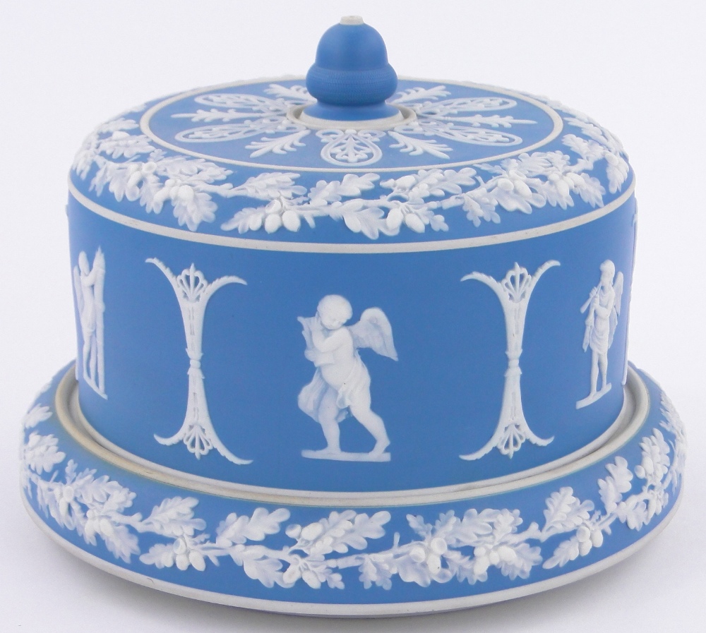 A Wedgwood blue and white Jasper cheese dish and cover, with relief classical designs,