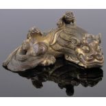 A miniature Chinese relief cast gilt bronze sleeping dragon, length 6.5cm.