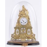 An ornate 19th century French gilt metal cased mantel clock, surmounted by a figure in armour,