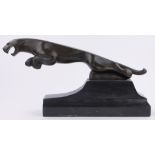 A reproduction patinated bronze Jaguar ornament, on black marble plinth base, length 60cm.