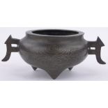 A small Chinese bronze censer, with inlaid silver swirling clouds and bat wings raised on 3 feet,