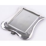 An Edwardian silver framed toilet mirror with strut back, makers marks L E, Birmingham 1906,