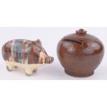 A Sussex Pottery brown glazed onion shaped moneybox, diameter 8.5cm and a pottery pig moneybox, (2).