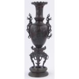 A Chinese bronze Meiji Period vase on stand, with cast scroll handles and relief embossed surround,