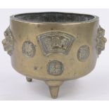 A Chinese relief cast bronze jardiniere, with raised handles, impressed seal mark under,