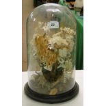 A Victorian glass dome on plinth containing a display of dried flowers.