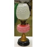 Antique oil lamp with pink milk glass font, and shade and chimney.