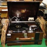 A HMV portable gramophone with a selection of 78 rpm records.