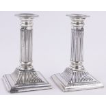 Pair of Edwardian silver Corinthian column candlesticks, on square plinth bases, Birmingham 1901,