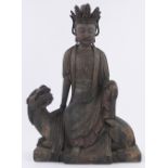 A large Chinese carved wood Buddha seated on a dragon, height 54cm.