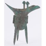 A Chinese verdigris bronze water vessel, with relief cast decoration, height 23cm.