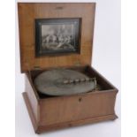 A 19th century walnut cased Polyphon, with marquetry panelled lid, playing 40cm discs,