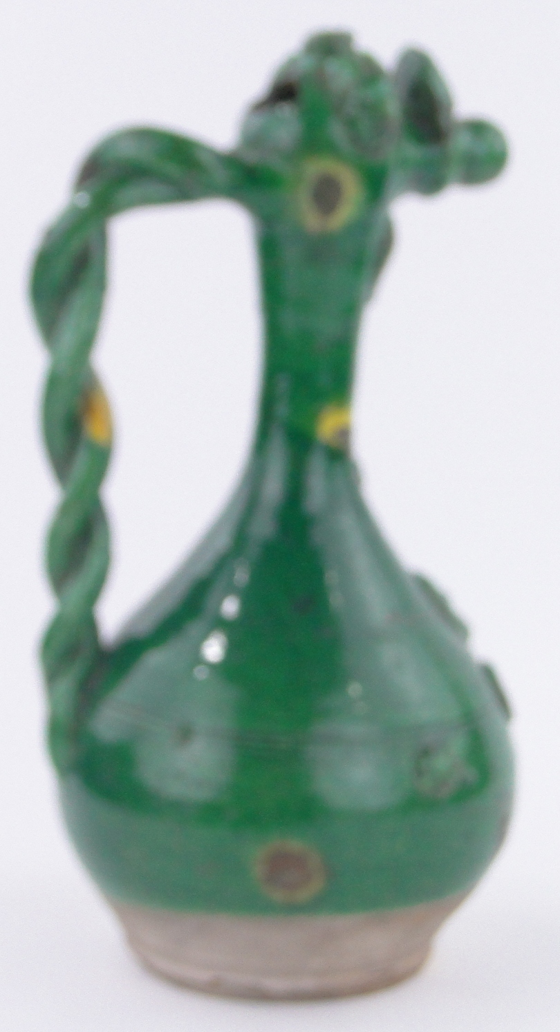 A large European green glazed pottery jug, with applied floral designs and twist handle, - Image 2 of 3