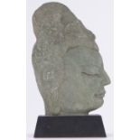 A Chinese relief carved green soapstone female head, on wooden plinth, overall height 33cm.