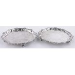 A pair of George IV circular silver card salvers, with cast shell borders and engraved decoration,