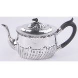 An Edwardian oval silver teapot, of half fluted form London 1906, 18.5 oz.