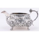 An ornate George IV silver sauceboat in Rococo style,