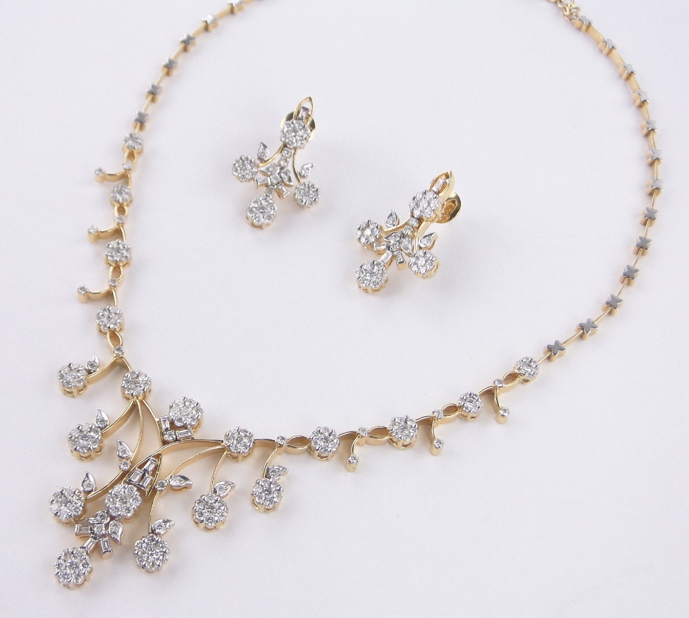 A fine quality 18ct gold diamond necklace and pair of matching earrings,