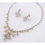 A fine quality 18ct gold diamond necklace and pair of matching earrings,