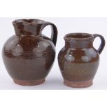 2 Sussex Pottery treacle glazed earthenware jugs, largest height 22cm.