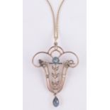 An Edwardian aquamarine and pearl set openwork pendant/brooch, unmarked gold settings,