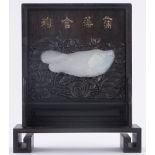 A Chinese relief carved jade fish, mounted in relief carved hardwood lily pond design plaque,