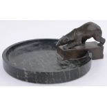 An Art Deco circular black marble and bronze dish, surmounted by a polar bear, circa 1920, unsigned,