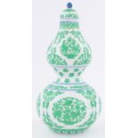 A Chinese porcelain double gourd vase and cover, with green floral decoration,