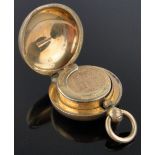 An 18ct gold filled sovereign case containing an 1876 gold half sovereign.