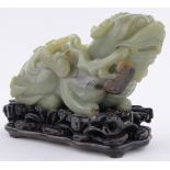 A Chinese carved yellow jade dragon, on ornate carved hardwood lily pond design stand, length 14cm.