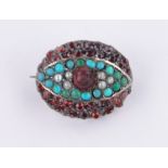 A 19th century garnet, turquoise and pearl set eye brooch, 21mm across.