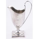 A George III silver helmet shaped cream jug, makers marks T S, London 1791, height 13.5cm.