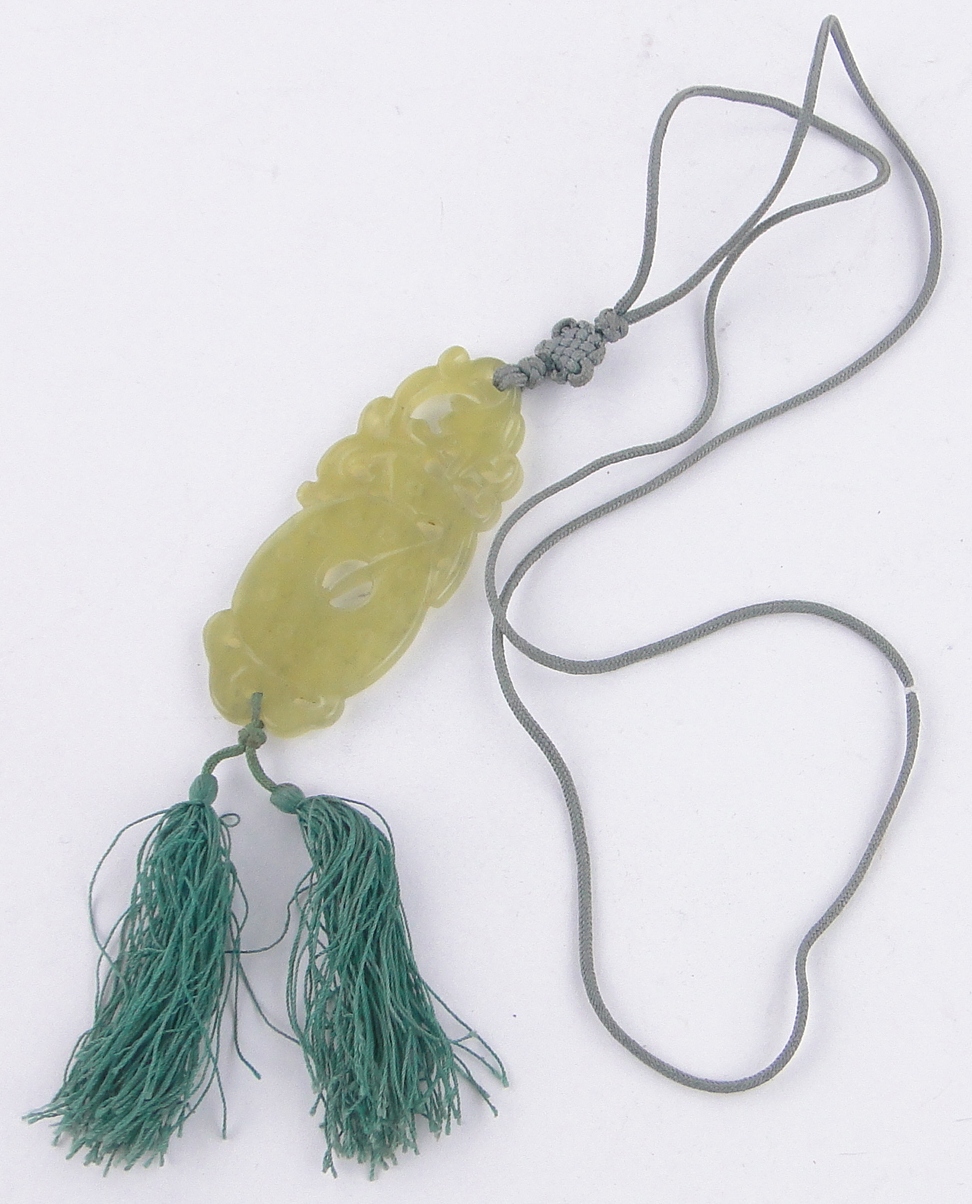 A Chinese relief carved and pierced jade pendant on silk cord, pendant length 70mm. - Image 2 of 3