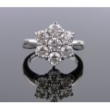 An 18ct white gold 7 stone diamond cluster ring, total diamond content approx.